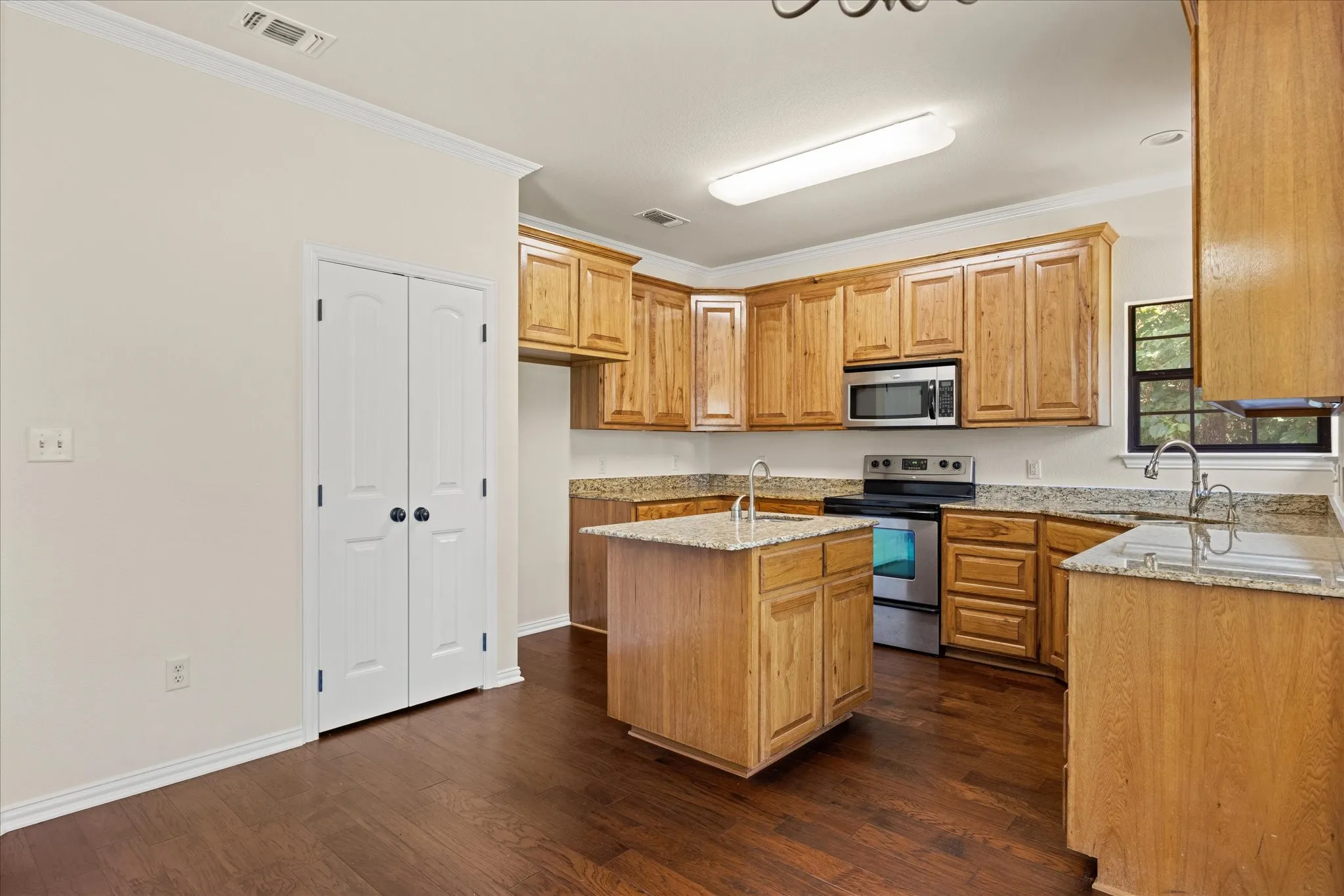 Kitchen has an island and pantry