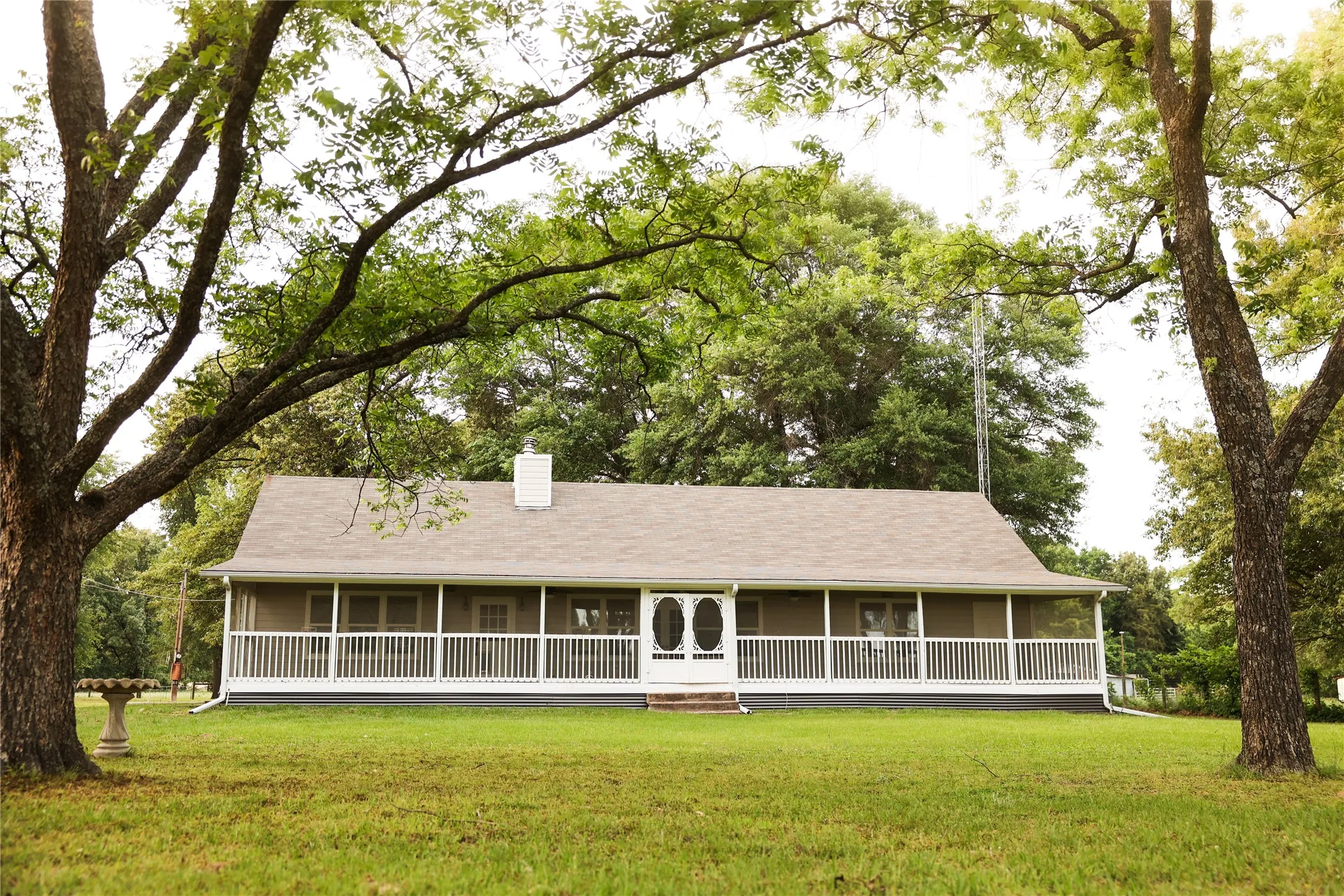 Home is surrounded by mature trees.