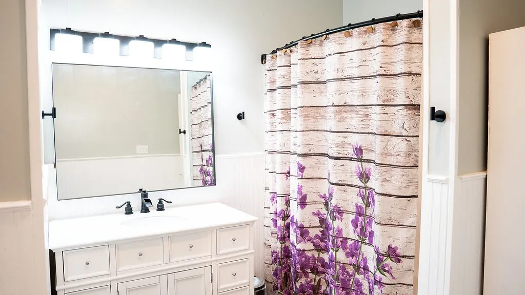Recent fixtures, vanity and lighting in primary bedroom