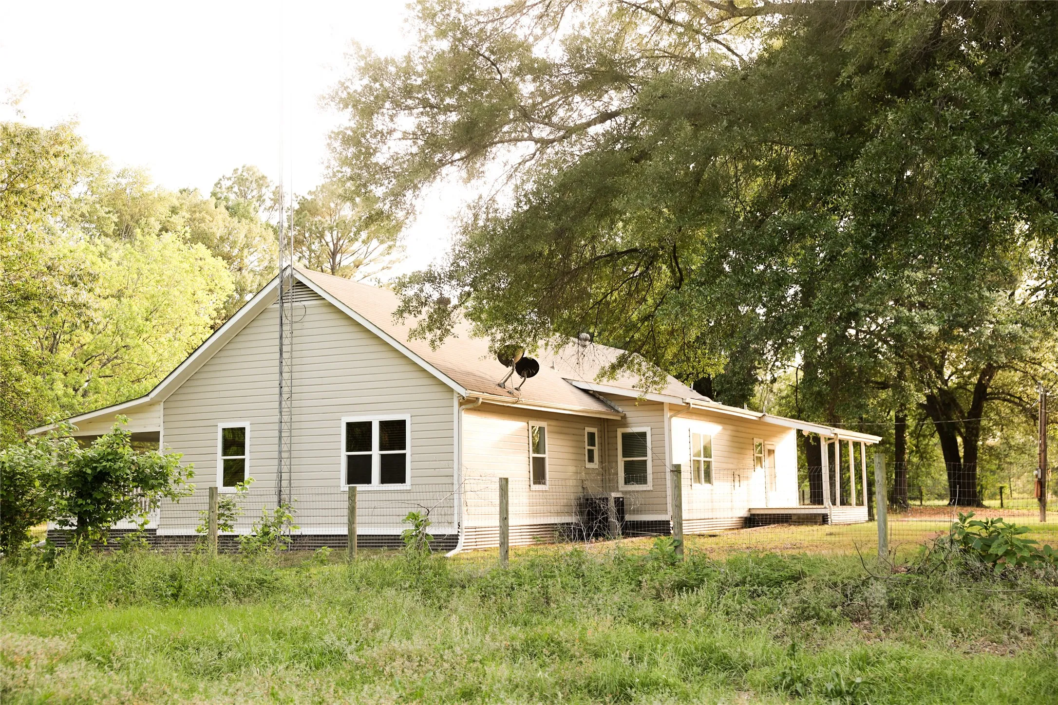 Mature trees shade the home
