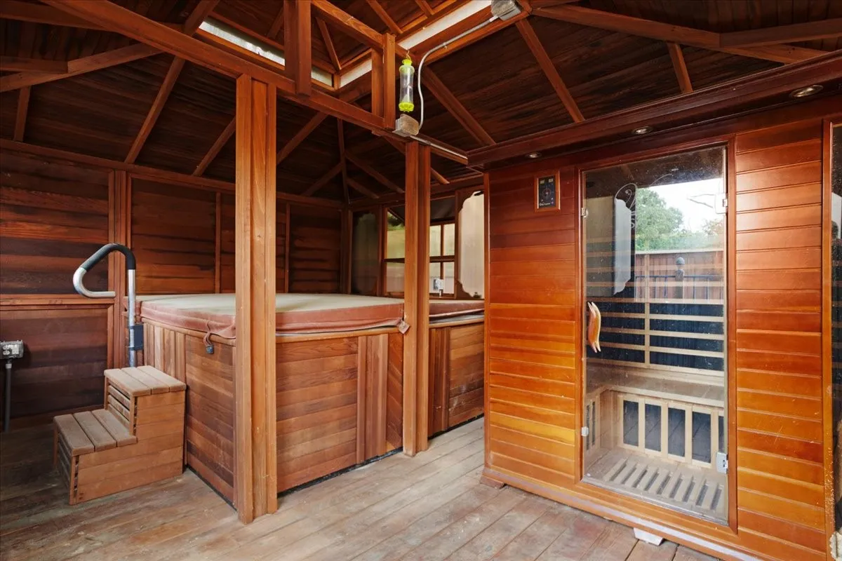Outdoor redwood spa room featuring an 8' x 8' hot tub and 5 person sauna.
