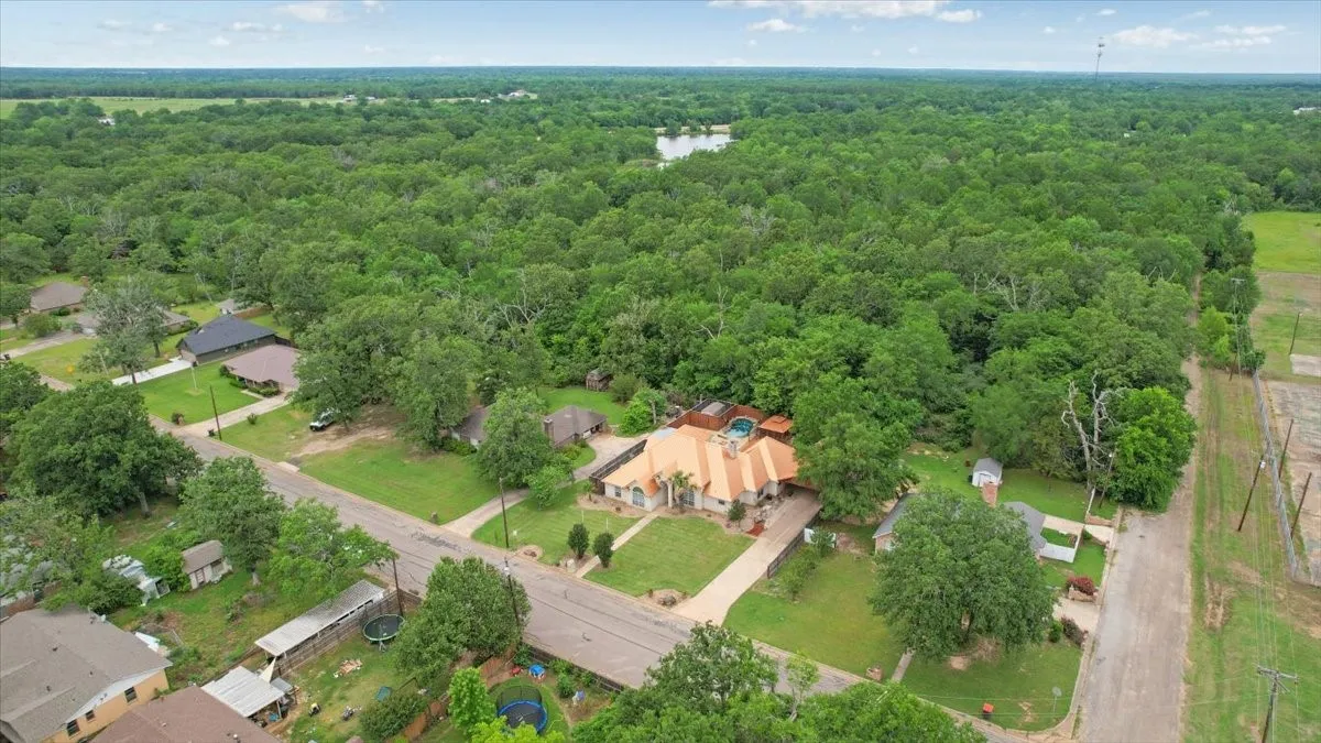 Aerial perspective showcasing a sprawling property with extensive green space