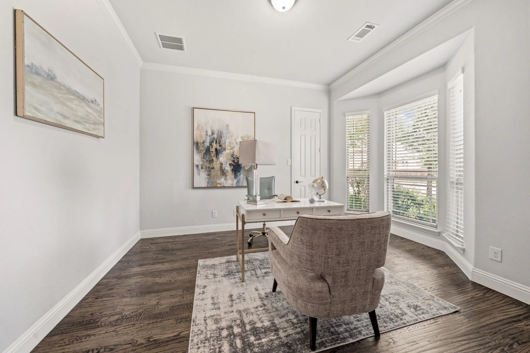Room featuring rich wood-finish flooring, white walls, and a bay window with blinds