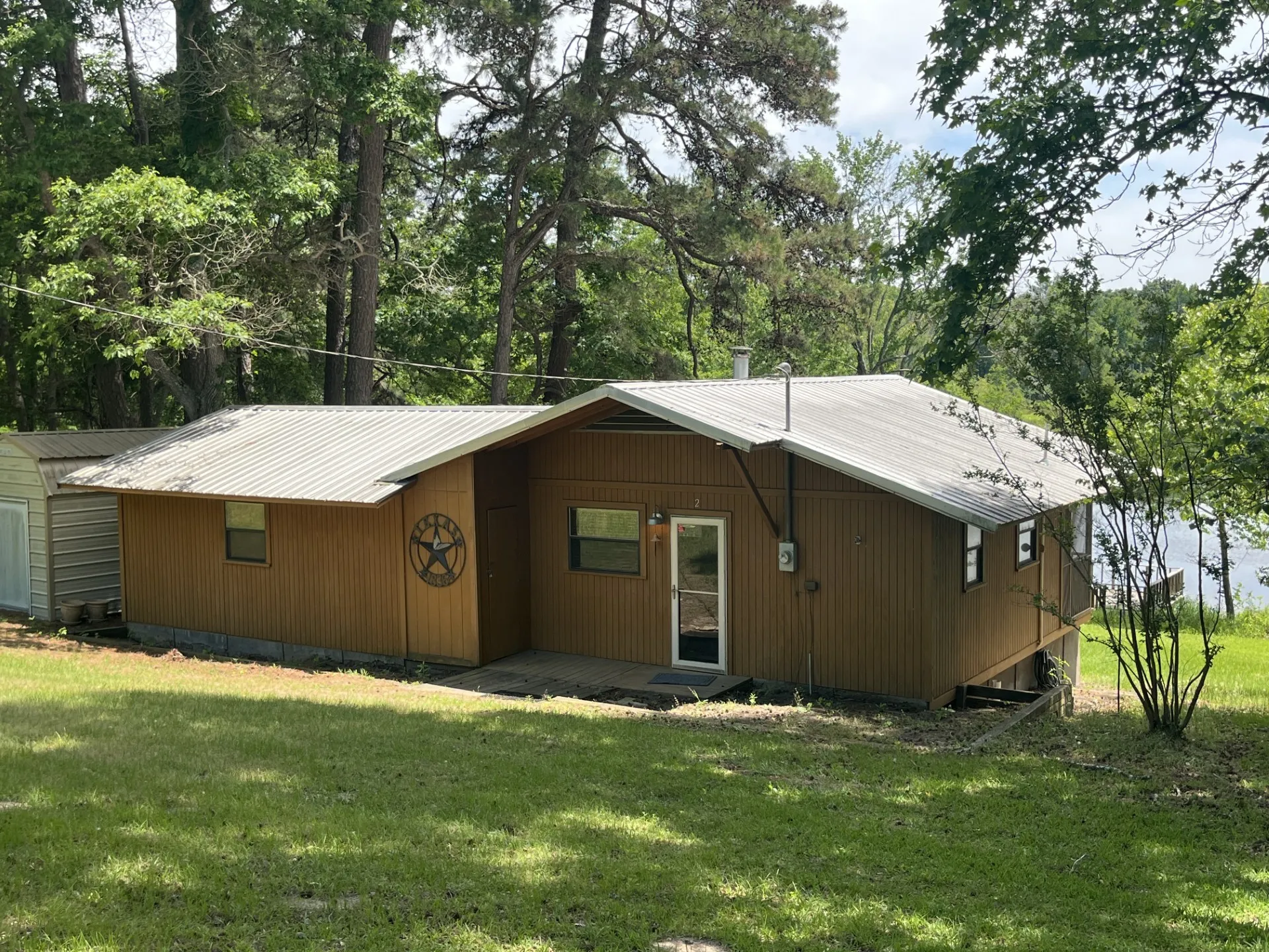 Brown siding exterior with a pitched metal roof