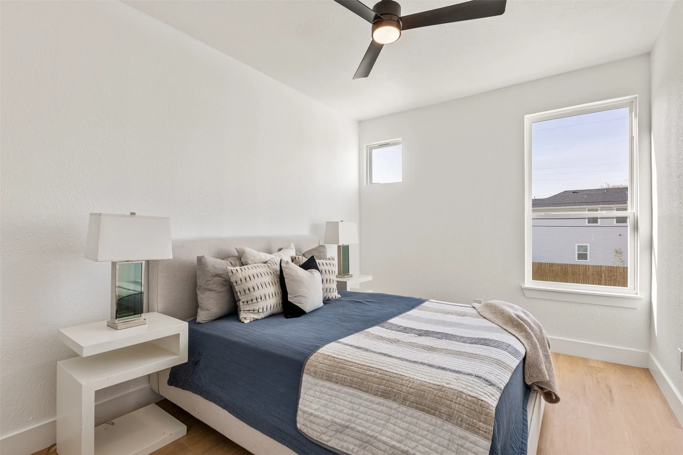 Bedroom with light wood-type flooring and a ceiling fan