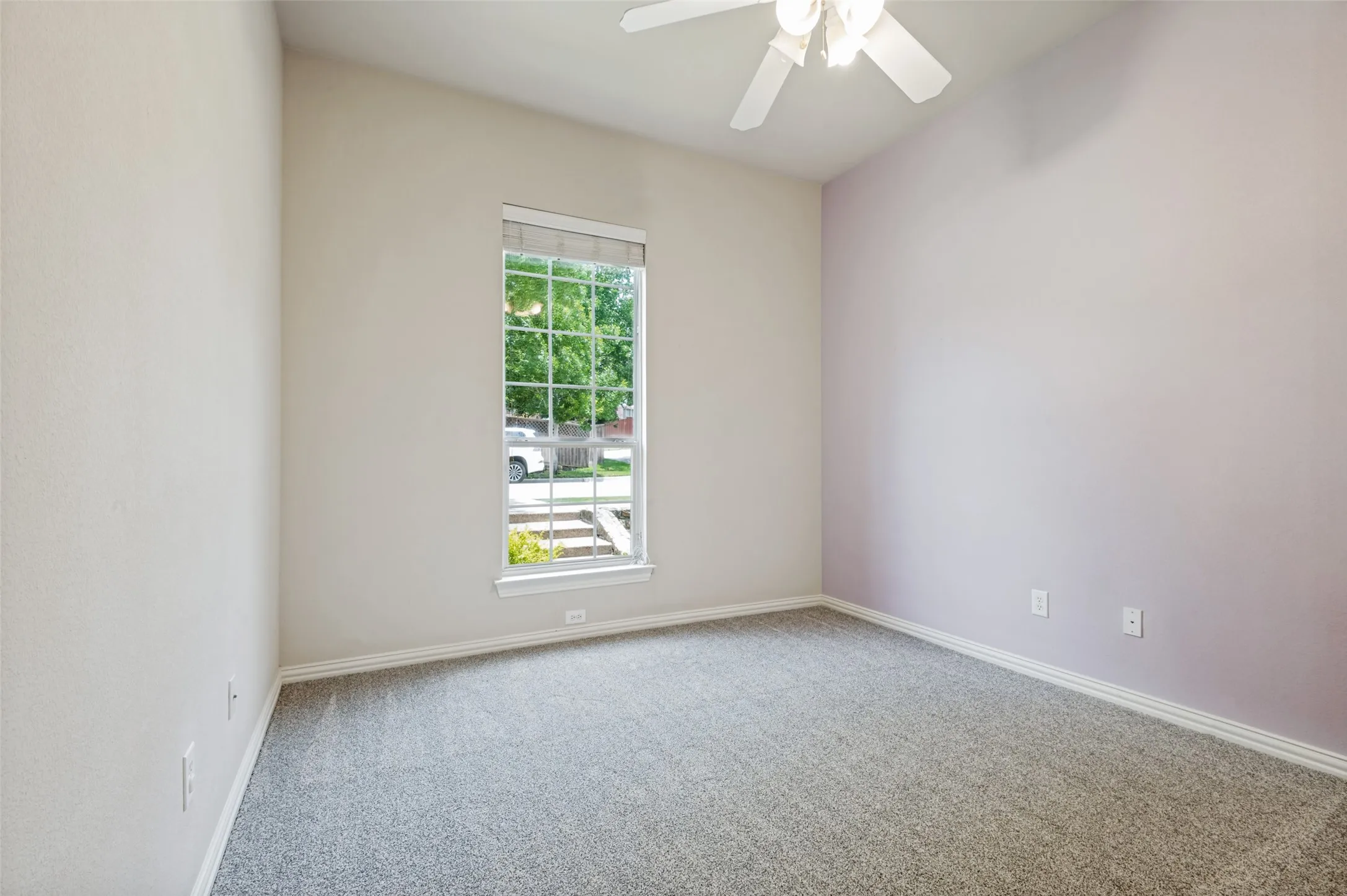 Light-filled room featuring a single window with grids, newly installed neutral carpet, a ceiling fan, high ceilings, large closet!