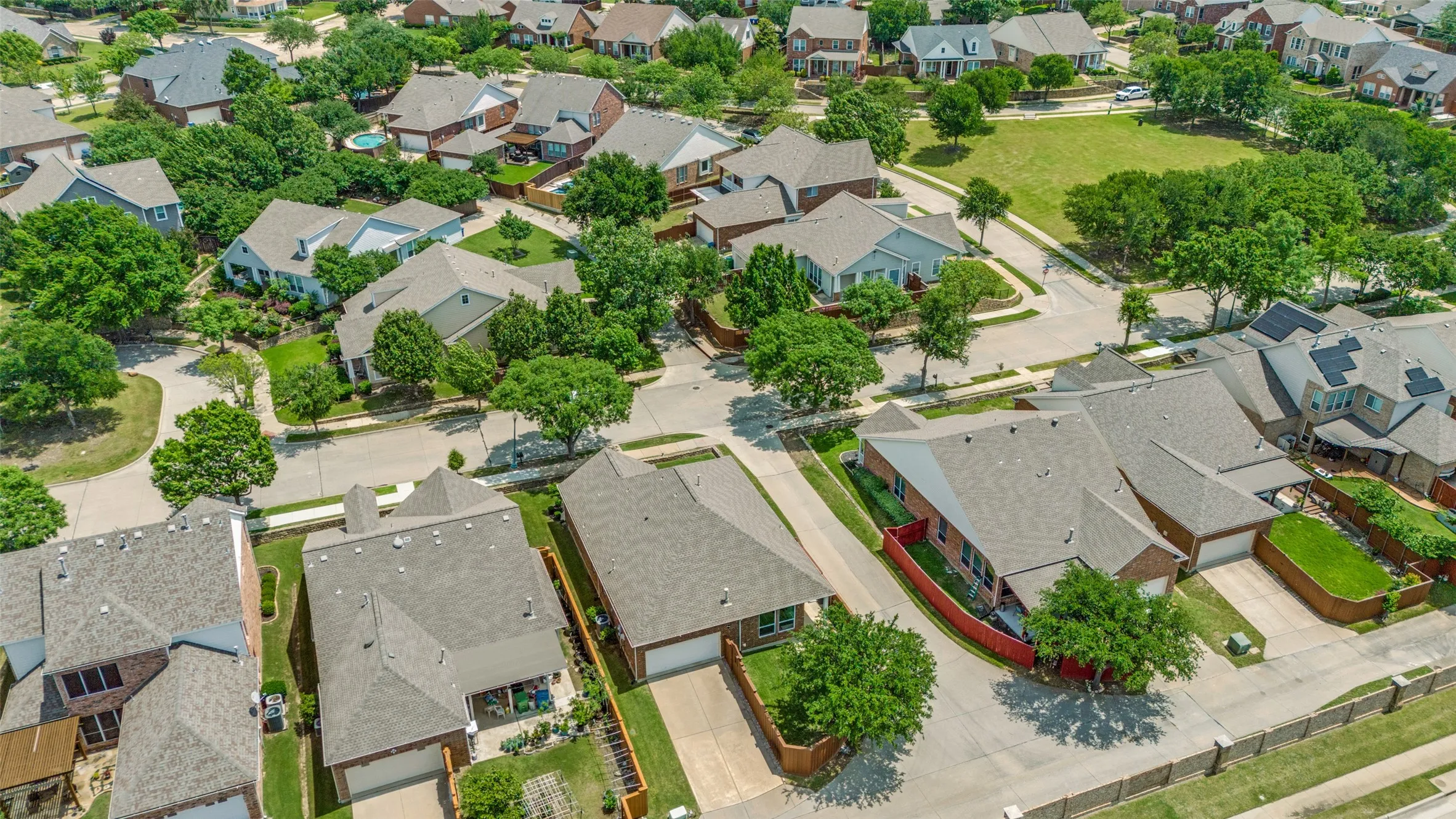 Aerial perspective showcasing The Homestead neighborhood with varied architectural styles. Lush Orchard Park view up the street!