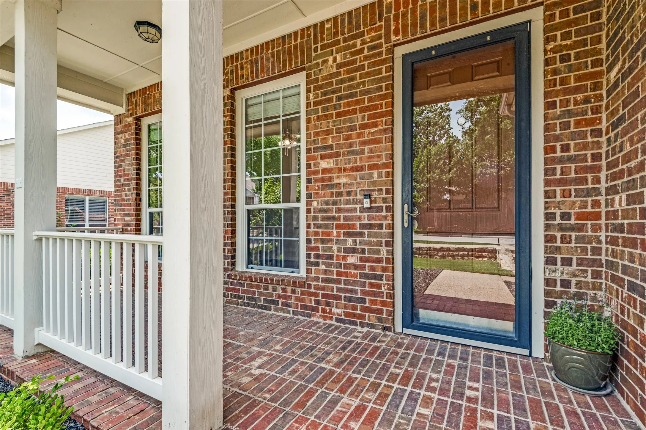Perfect front porch spot to start or end your day and a great view of Orchard Park from here! Brick exterior featuring a covered porch, white columns, and a coordinating railing.