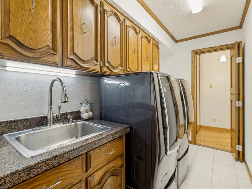 Designed for convenience, the dedicated utility room includes a sink, space for an additional freezer or refrigerator, accommodates a full-size washer and dryer, and offers both gas and electric dryer hookups!