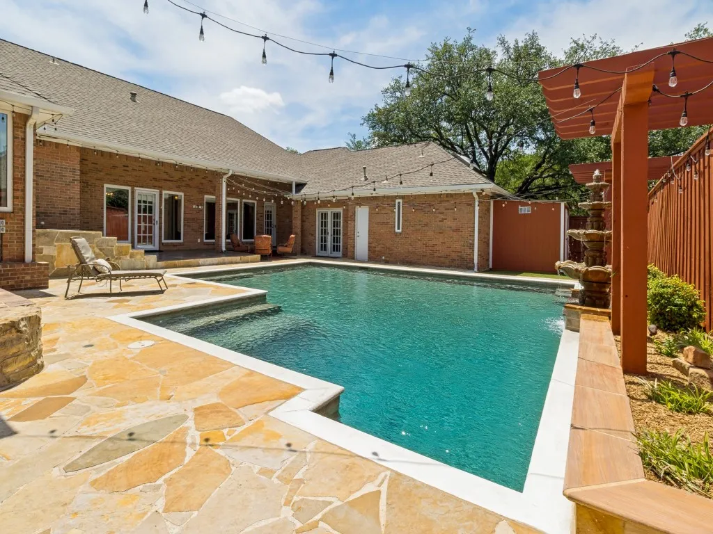 Designed for outdoor enjoyment, the pool and backyard feature a PebbleTec finish, water fountain, flagstone decking and a covered patio!