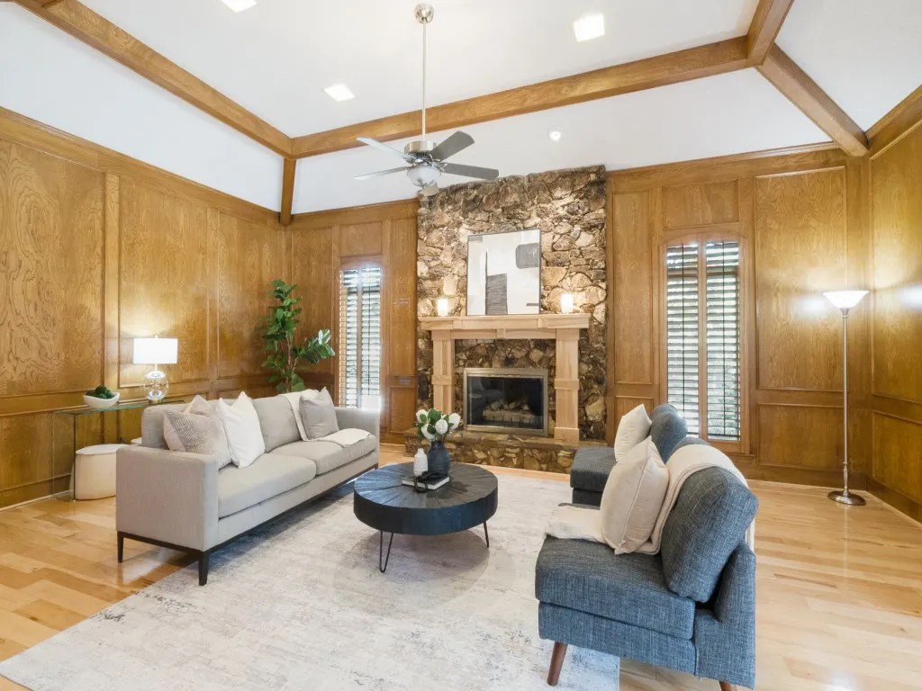 Rich wood paneling, plantation shutters and an exquisite stone fireplace complete the room!