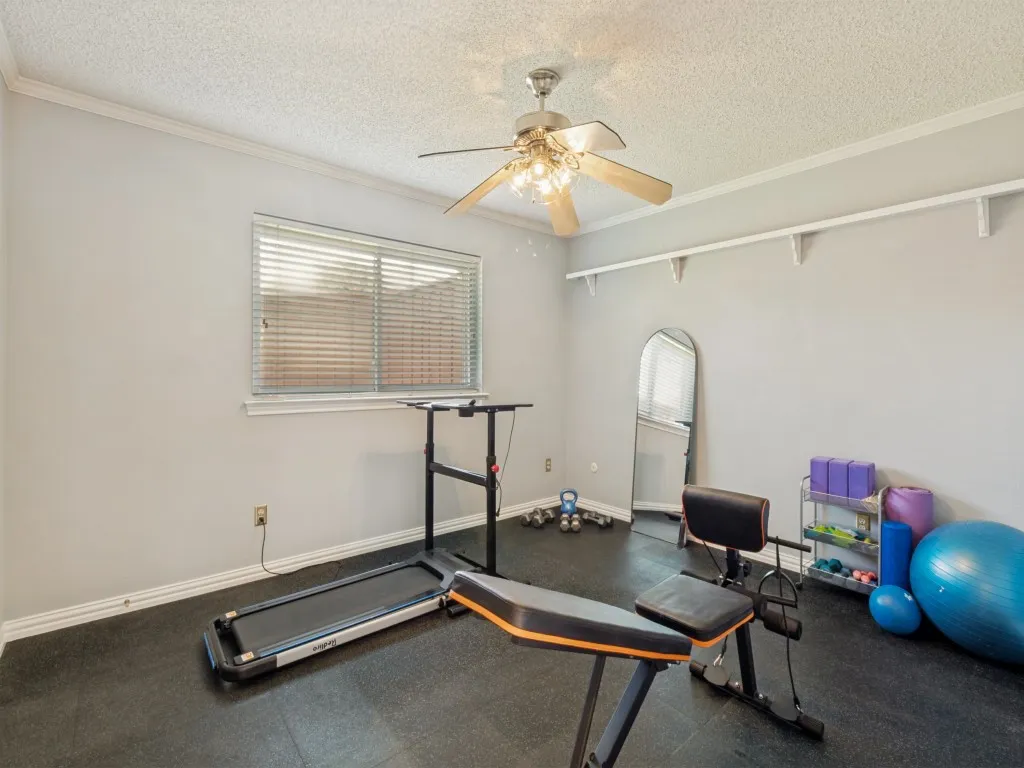 This bedroom, currently used as a workout space, is approximately 13' x 11' and includes a walk-in closet!