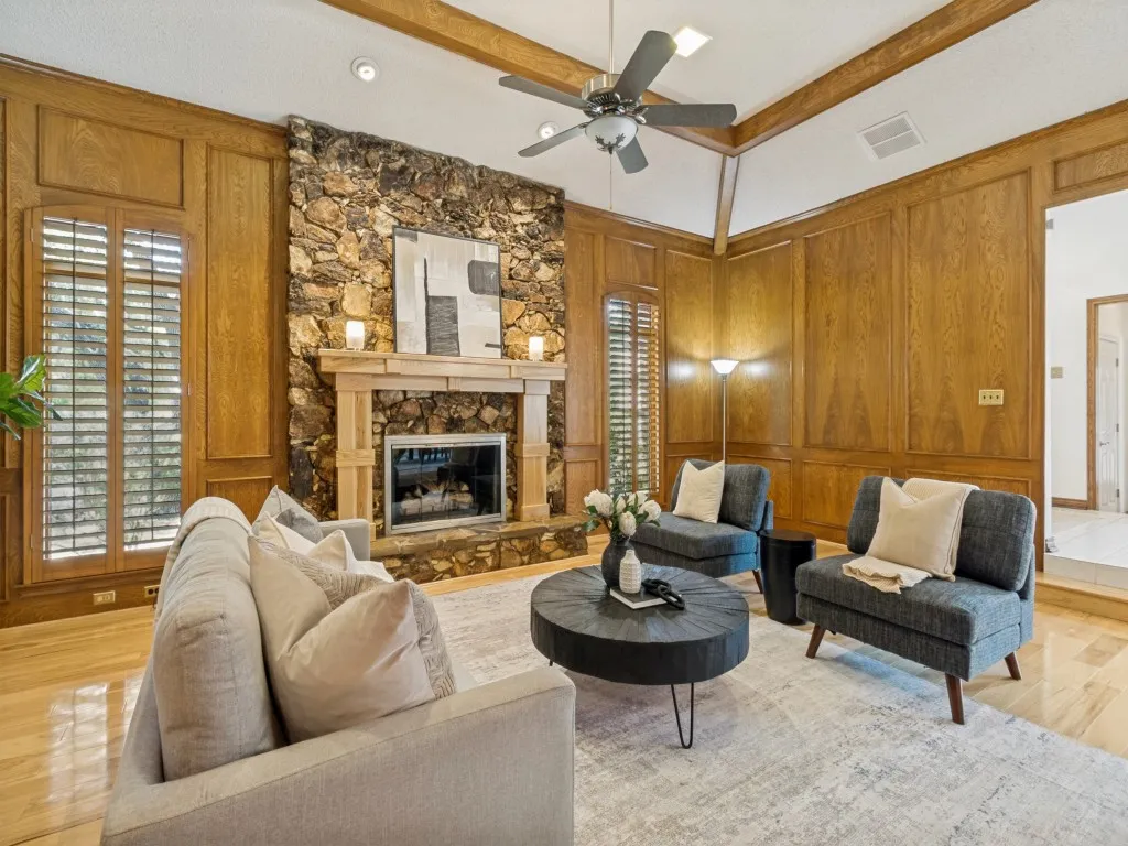 The formal living room is located just off the front entry featuring hickory wood floors and a custom hickory fireplace mantle!