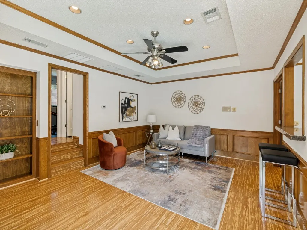 The den showcases bamboo tiger-strand wood floors, recessed lighting, built-ins, and a well-appointed wet bar!