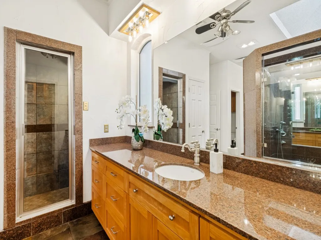 A separate steam unit and another pair of ceiling recessed Martin Logan speakers add an additional layer of luxury to the primary bath!