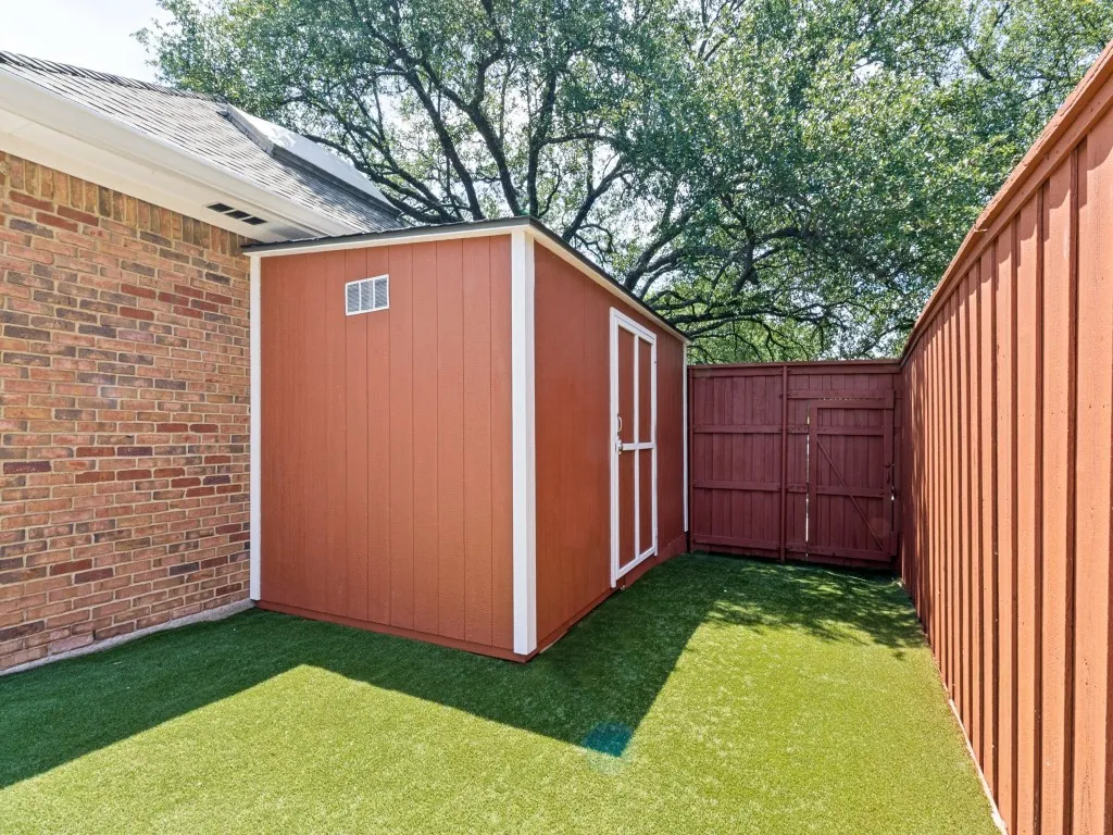 Ideal for lawn and pool equipment, the custom lean-to storage shed includes lighting and a convenient workbench!
