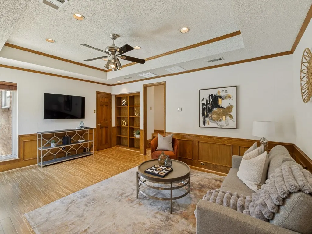 The den captures serene backyard and pool views and provides easy outdoor access!