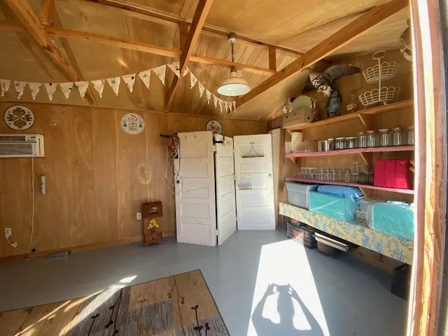 Interior space featuring wood-paneled walls and exposed ceiling beams