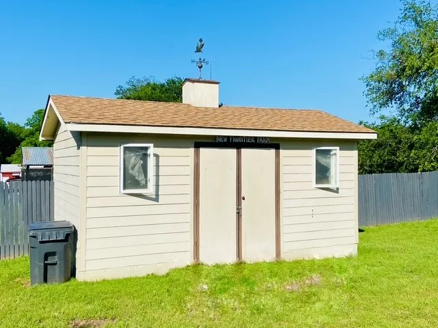 Detached storage shed with horizontal siding and a gambrel roof