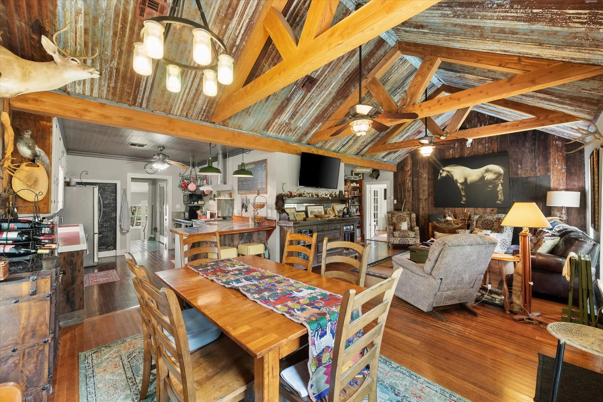 Vaulted ceiling with exposed wood beams and corrugated metal panels