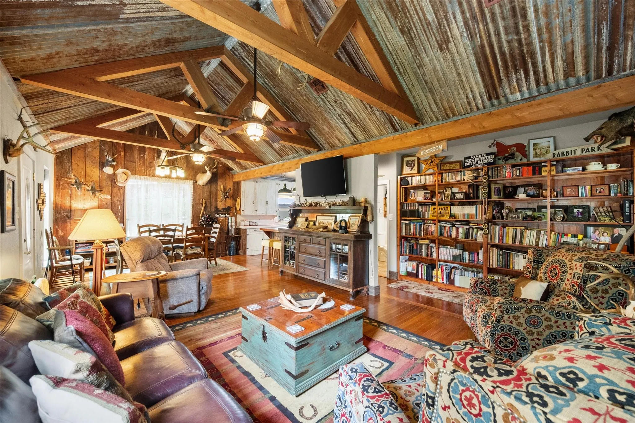 Vaulted ceiling with exposed wood beams and corrugated metal finish