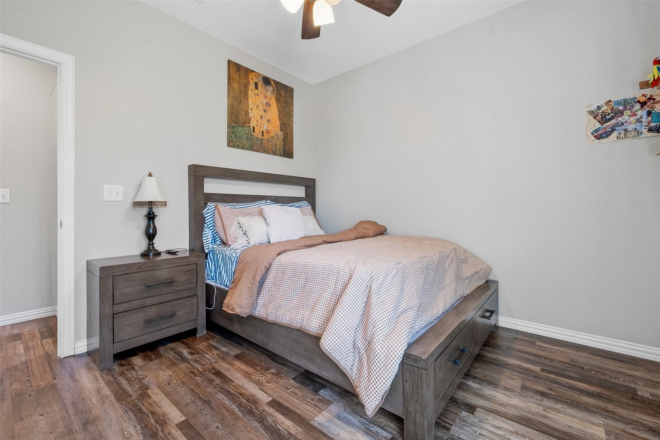Wood-finish flooring throughout, featuring a neutral wall color and white trim