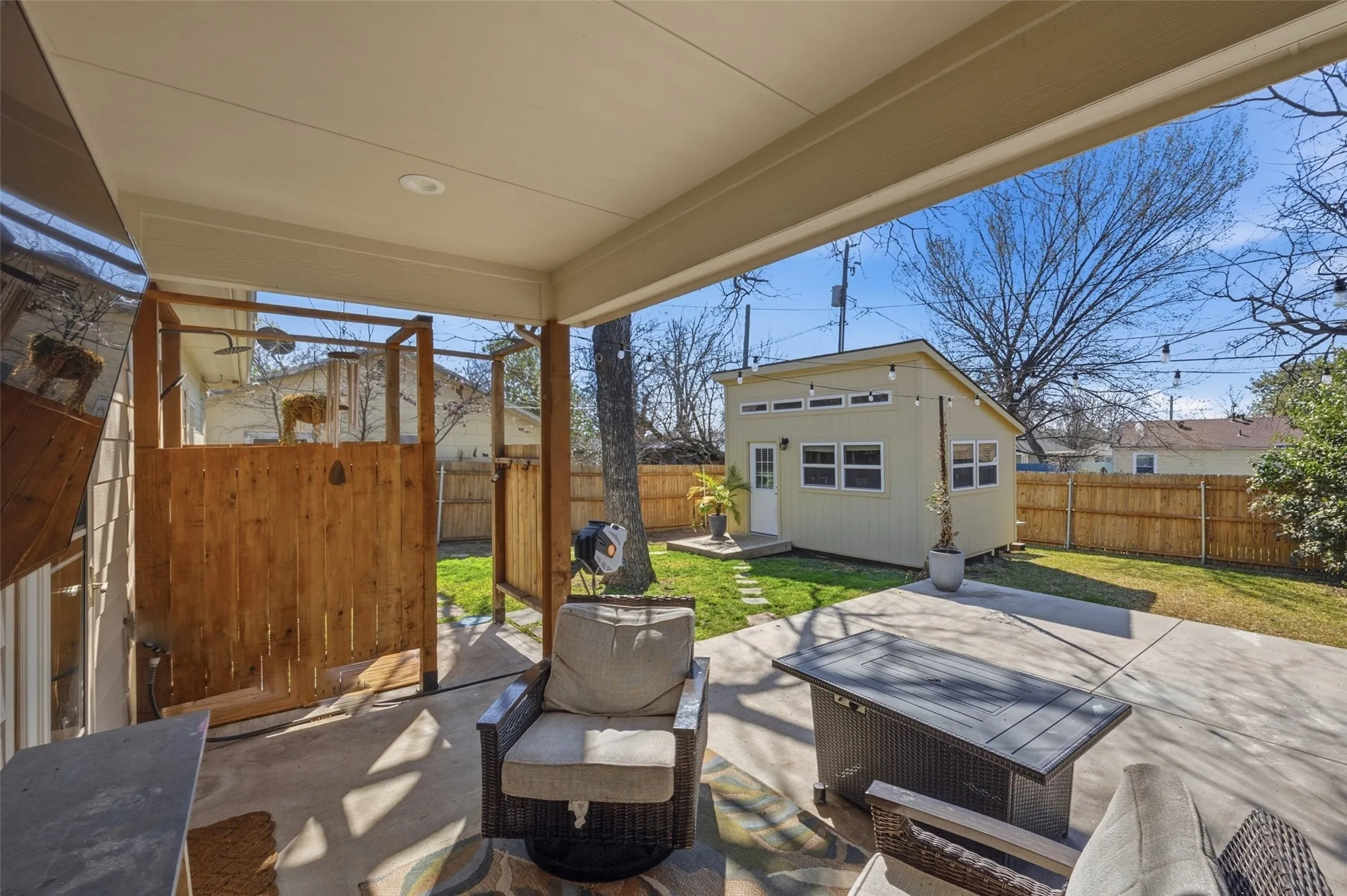 Covered patio featuring recessed lighting, a concrete slab, and a wood privacy screen