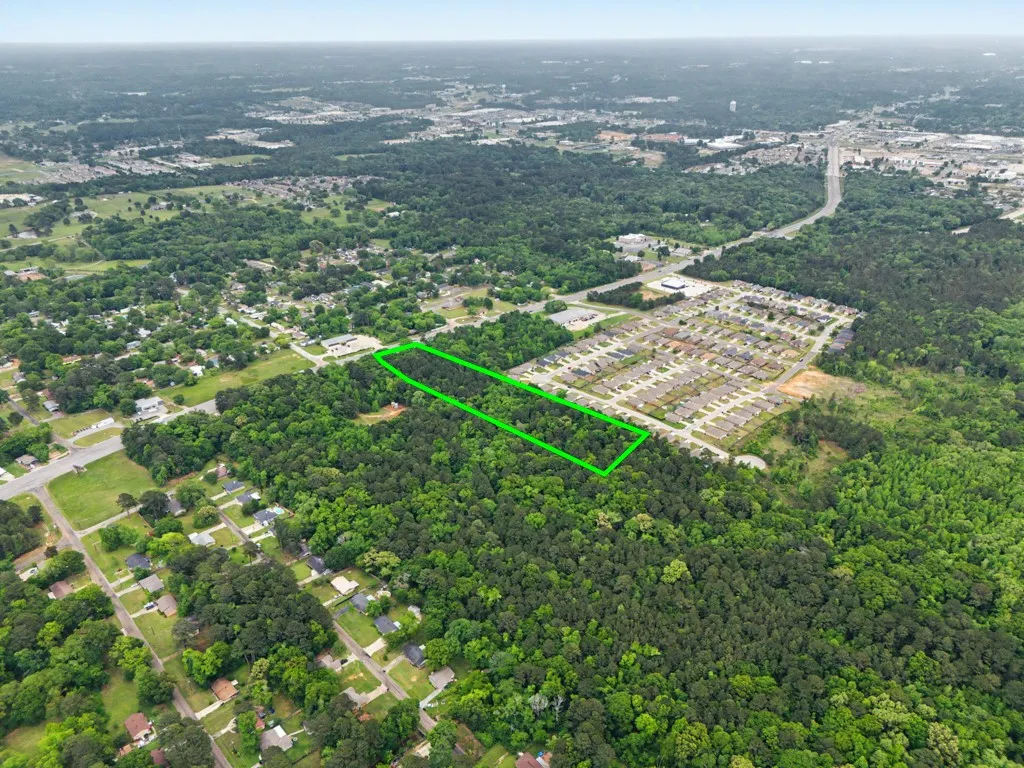 Expansive wooded parcel outlined in green, featuring significant tree coverage