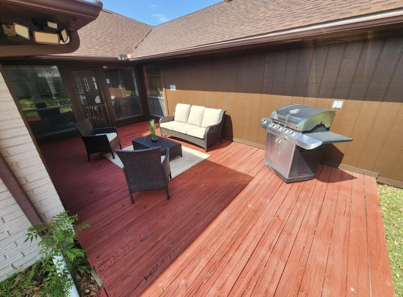 Expansive outdoor deck featuring wood flooring and a brown shingle roofline