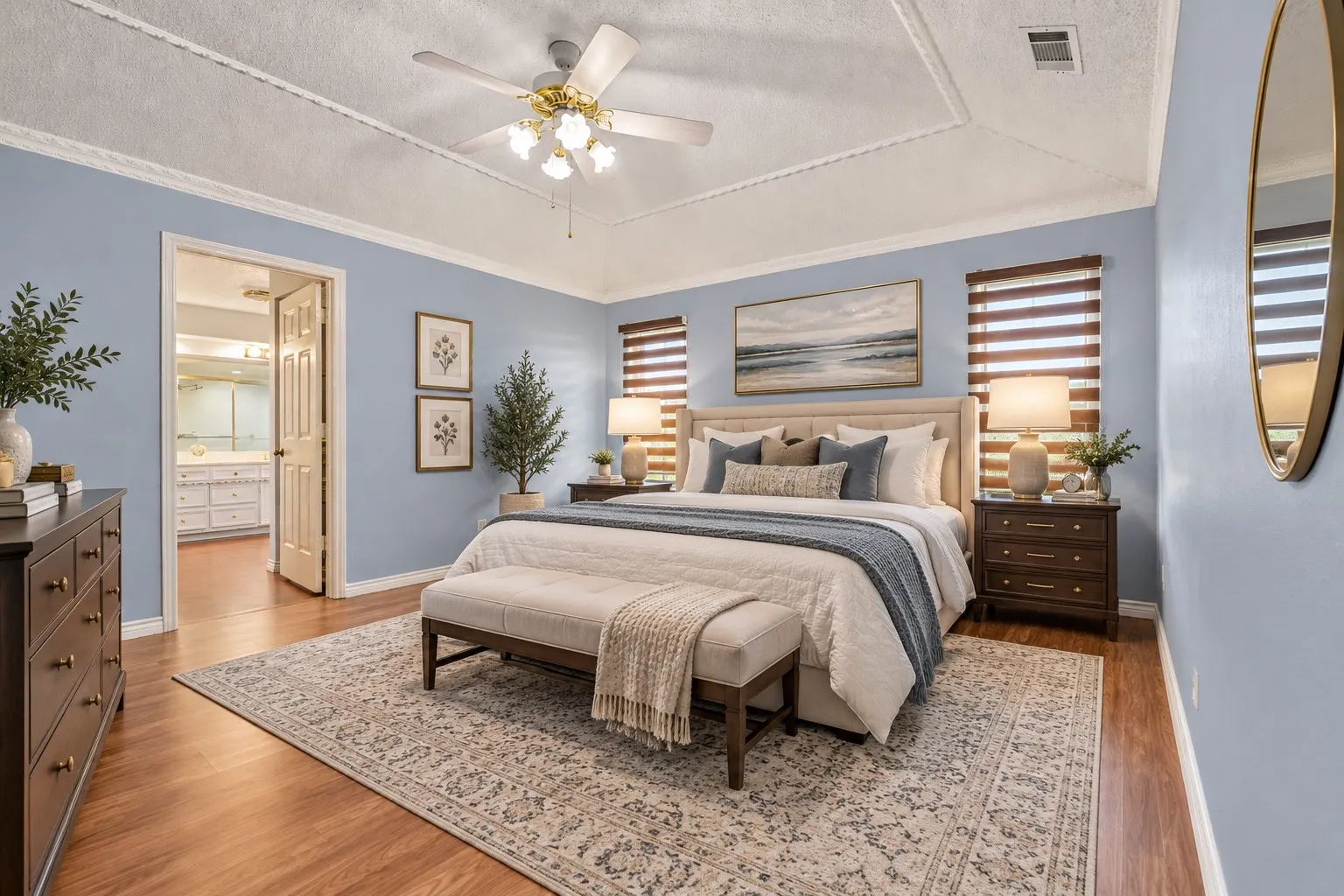 Vaulted ceiling with a ceiling fan, light blue walls, wood-finish flooring, and white trim