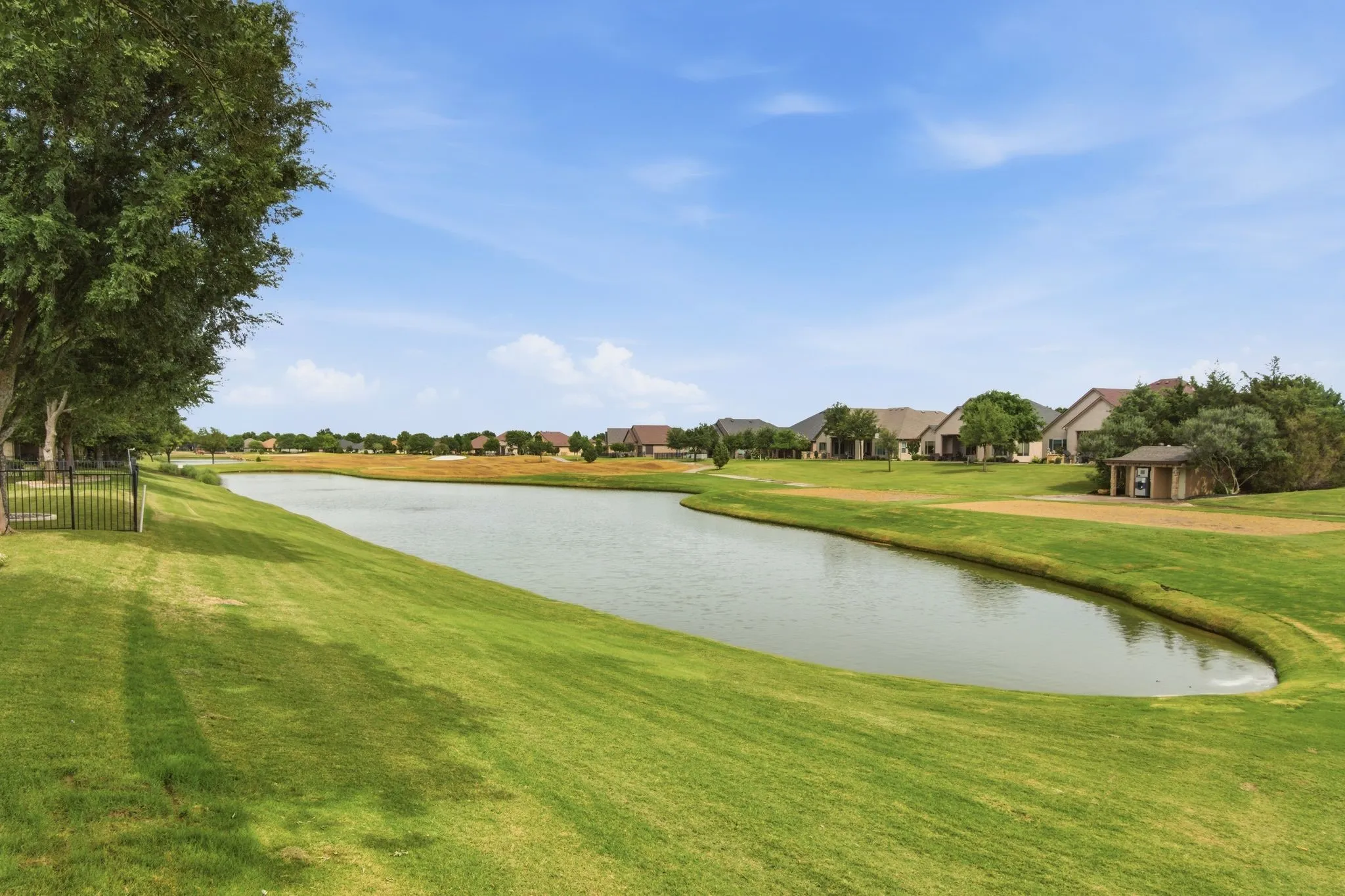 Aerial view of the 6th hole of the South Course of the Wildhorse course, pond and adjacent green spaces