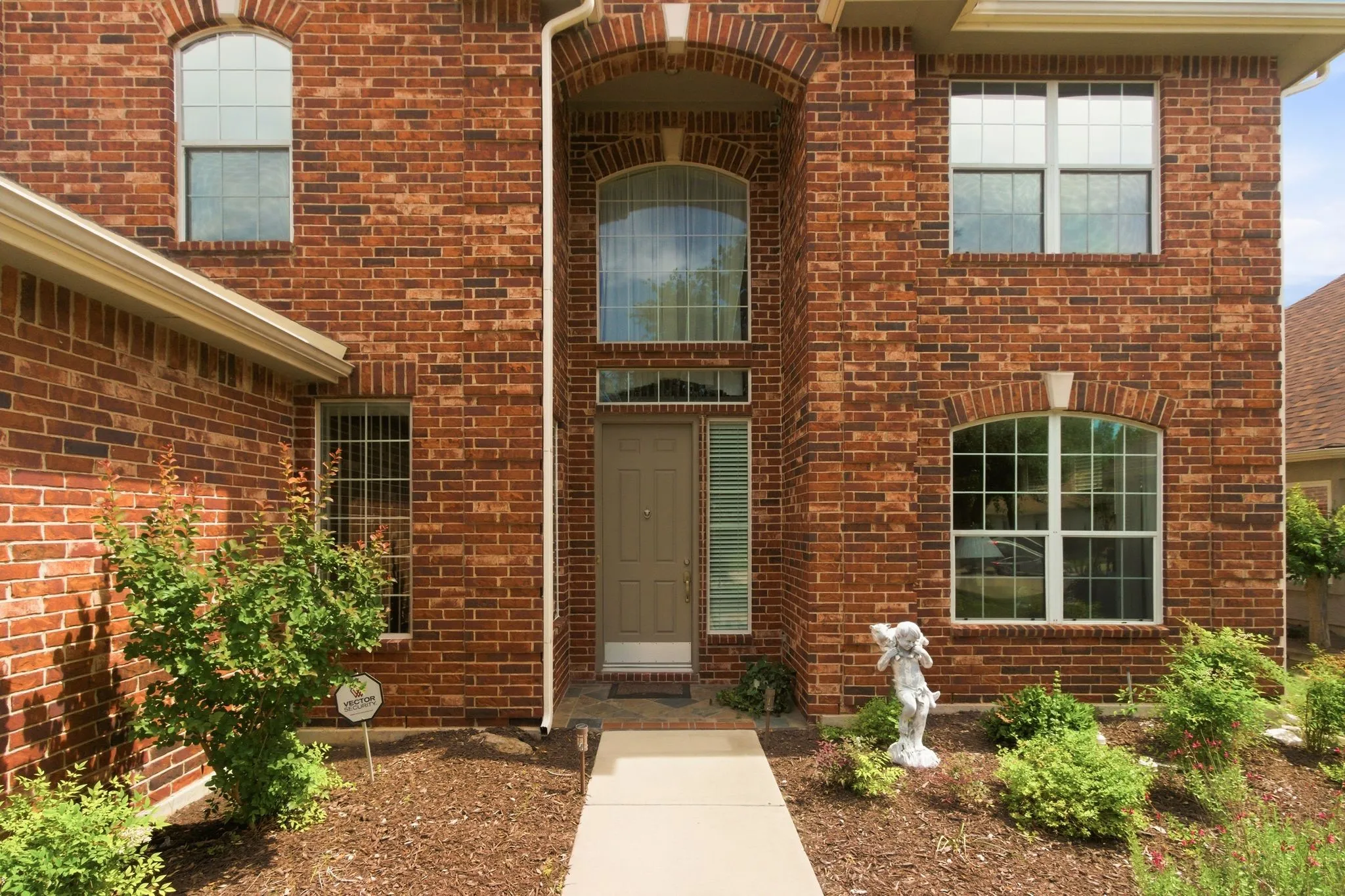  Notice the prominent two-story entryway with contrasting light-colored trim