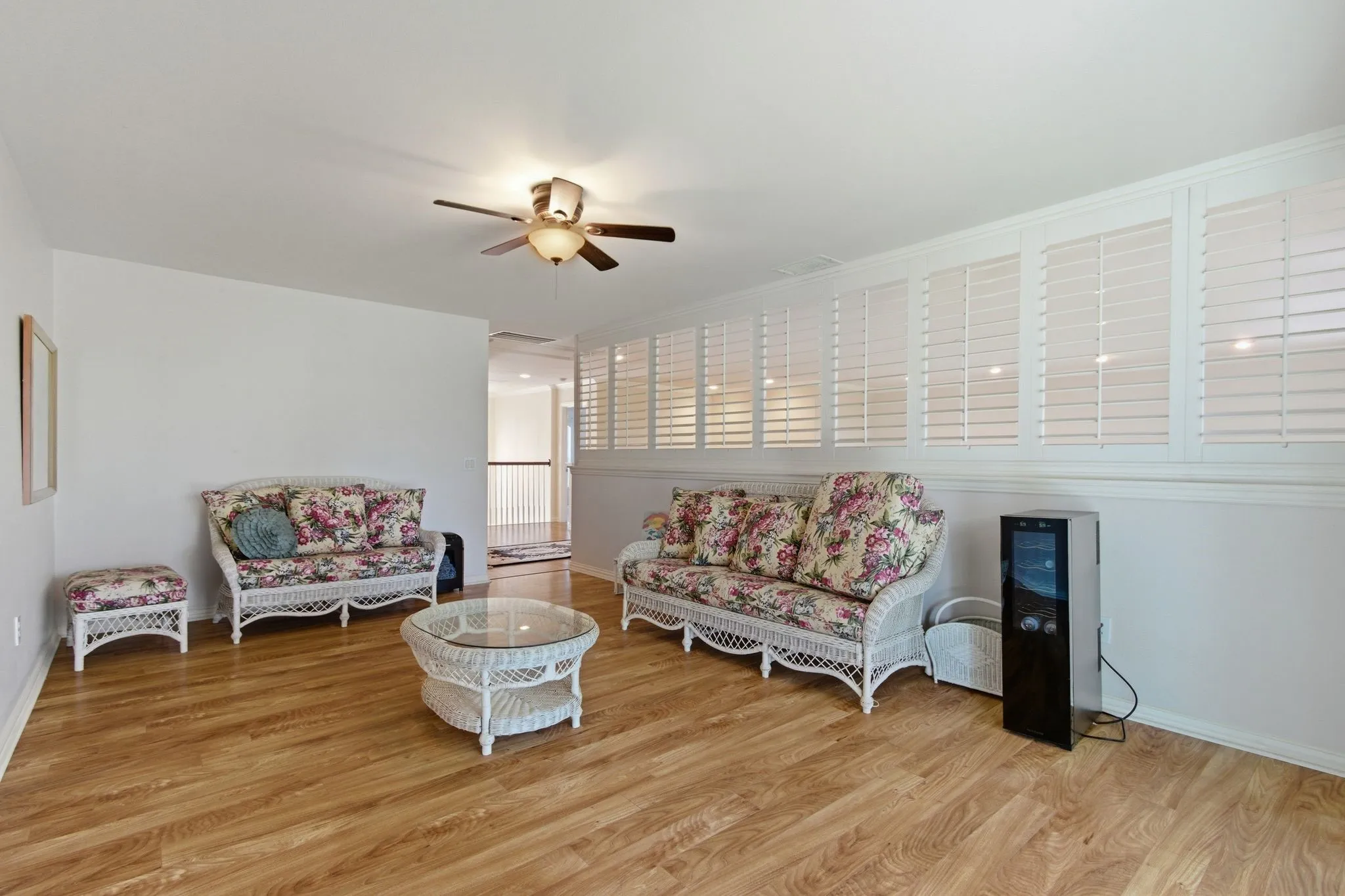 2nd floor Bonus Room featuring wood-finish flooring, a ceiling fan. Leads out to the balcony.  This could be used as a man's cave, she shed, or grandkid's retreat.