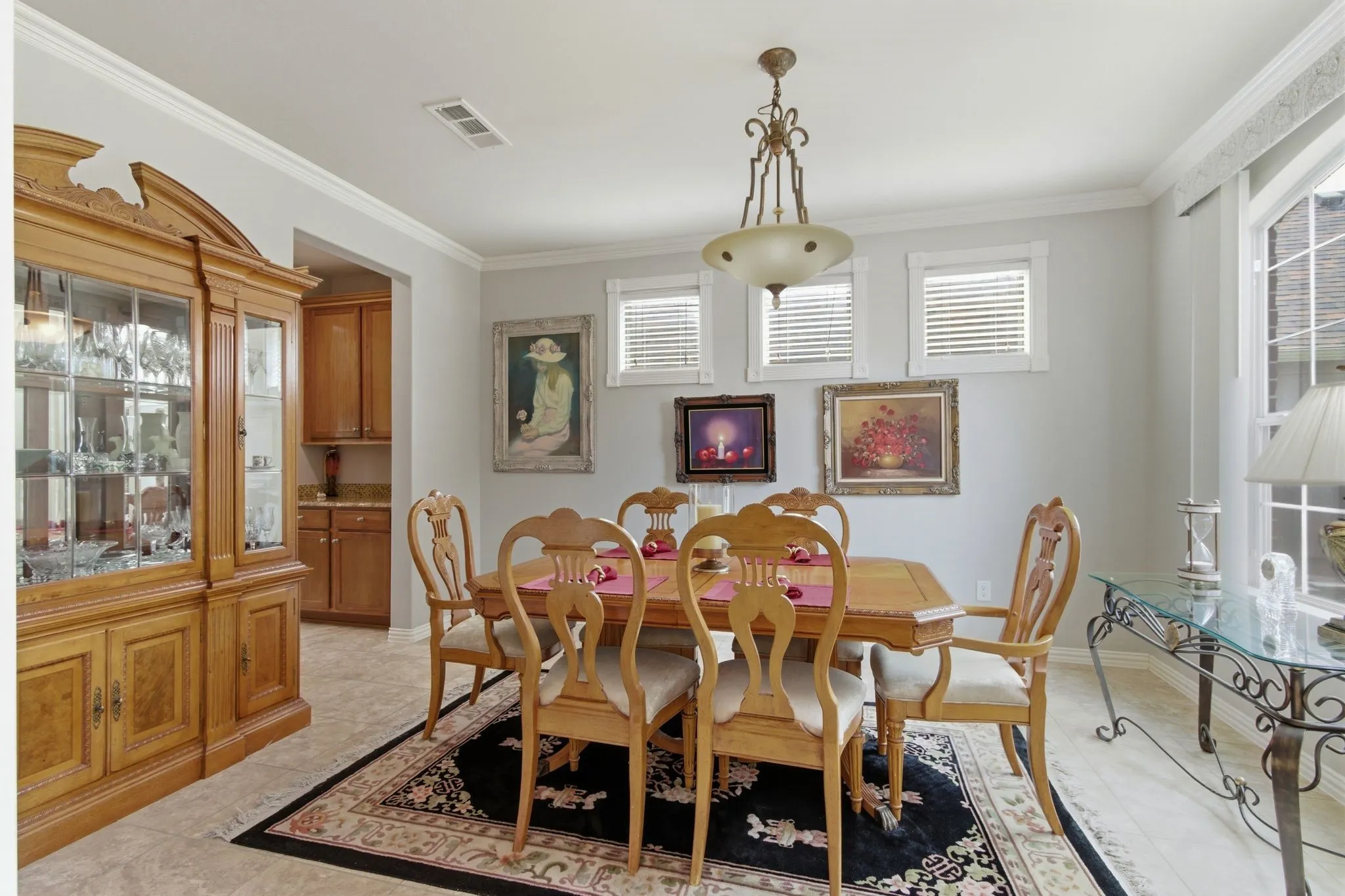 Formal dining area featuring a decorative chandelier, crown molding, and light-toned walls