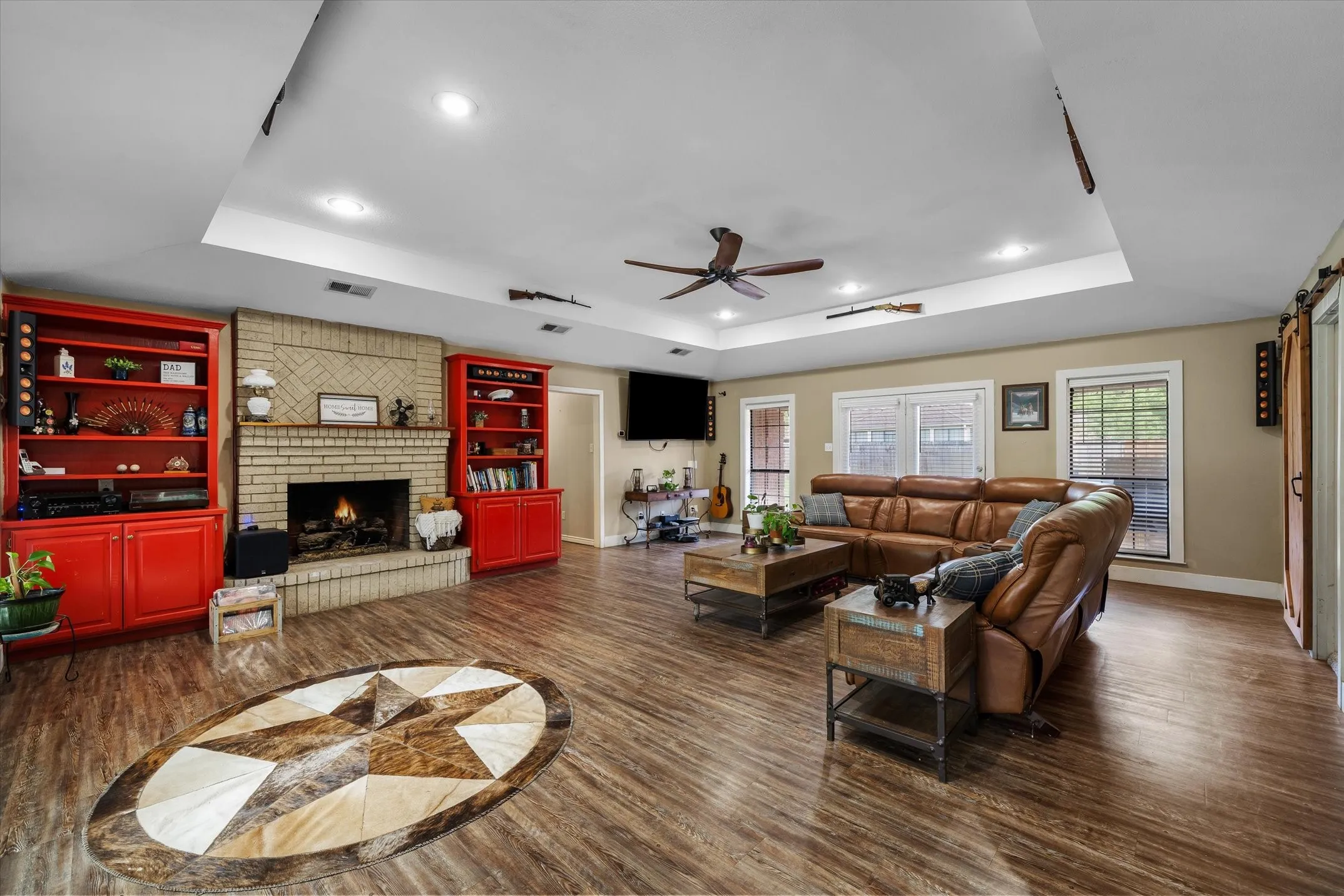 Beautiful brick fireplace surrounded by built-in cabinets.