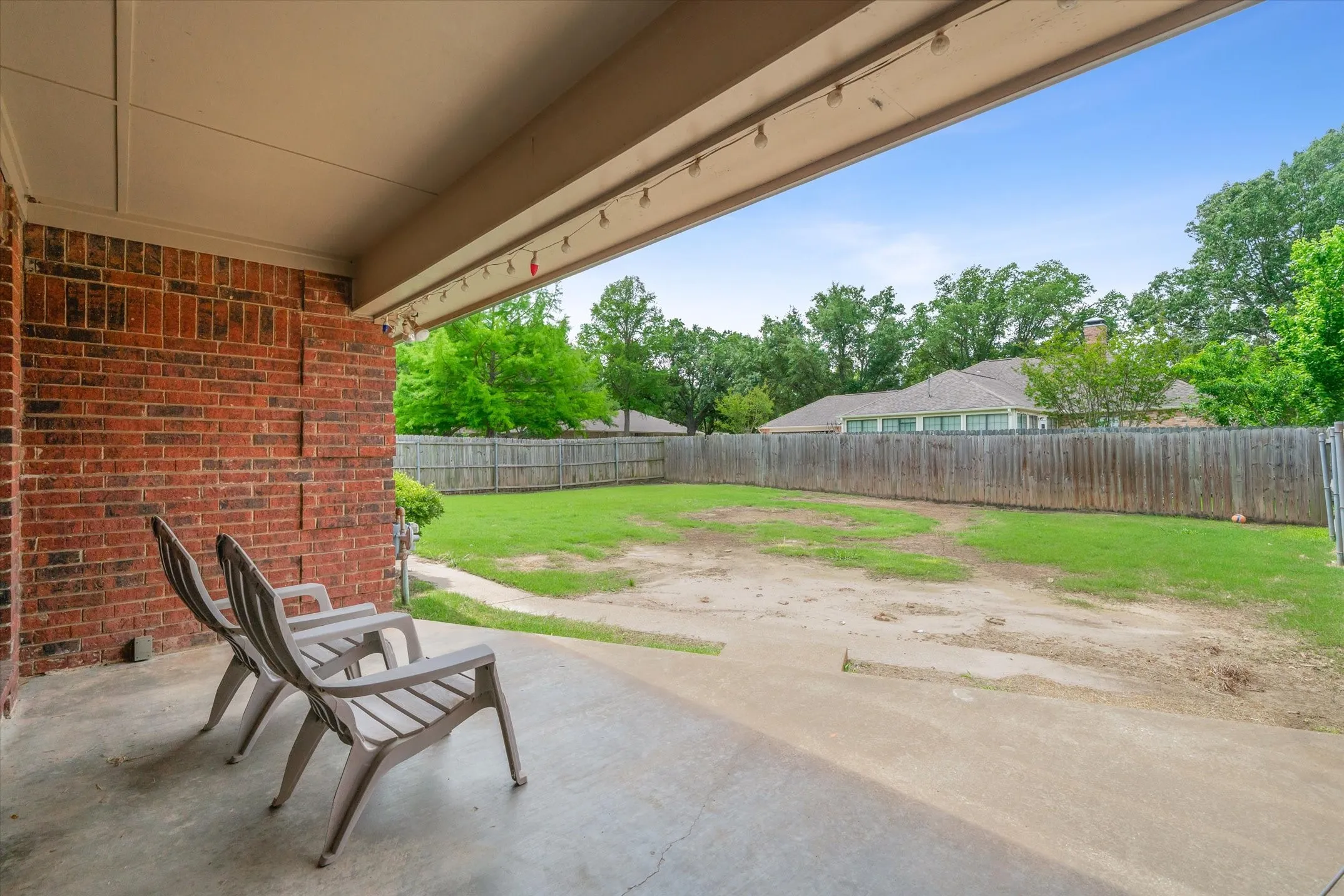 Private, covered patio looking over the fenced backyard