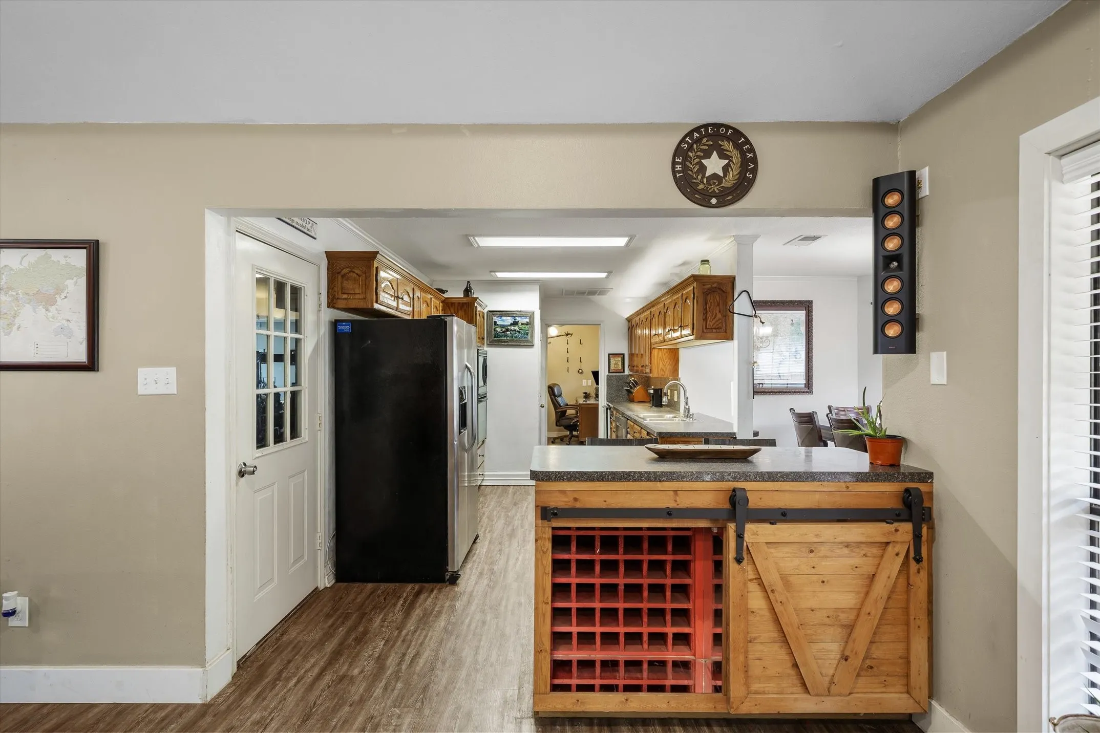To the right is the kitchen with restored cabinets, wine storage and peninsula bar.
