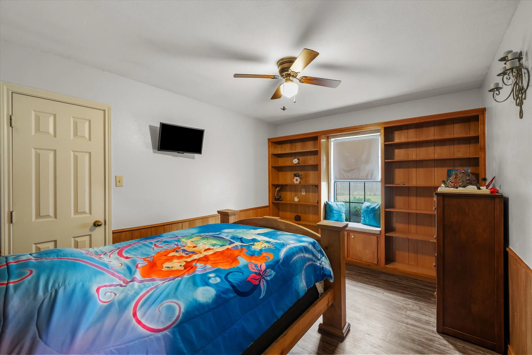 Bedroom with built-in shelving, window seat and walk-in closet