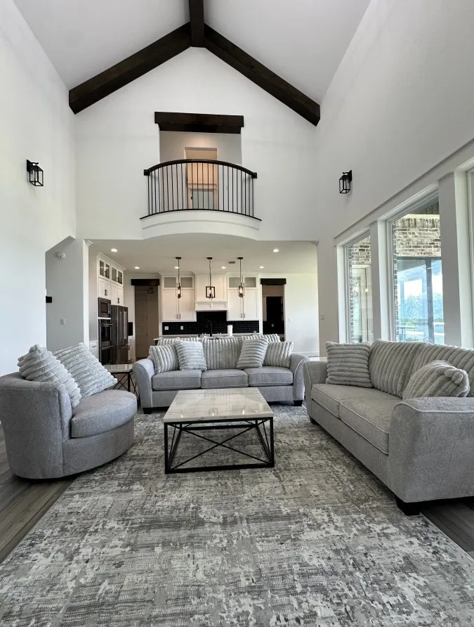 Living area featuring high vaulted ceiling, wood finished floors, and beam ceiling