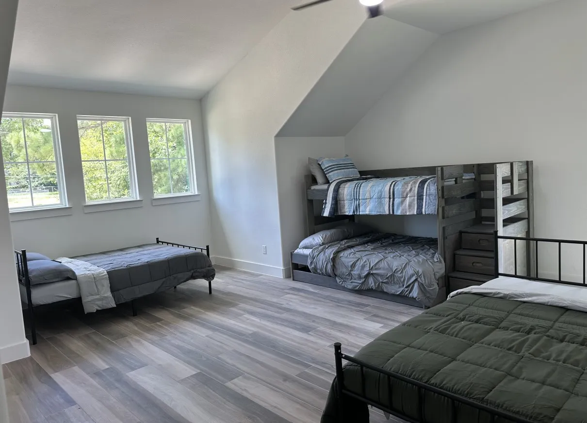 Bedroom with vaulted ceiling and wood finished floors