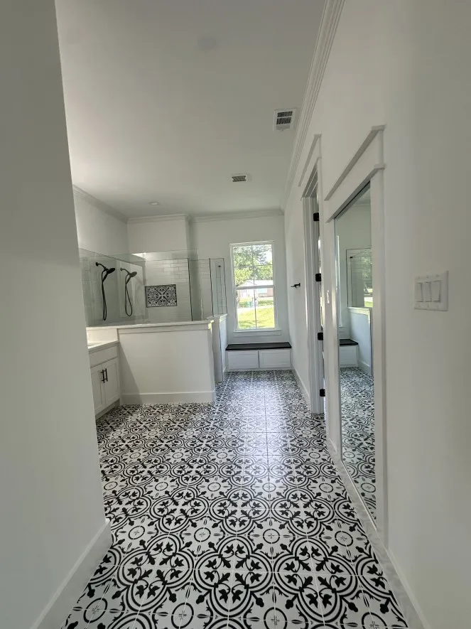Full bath featuring ornamental molding, a tile shower, and vanity