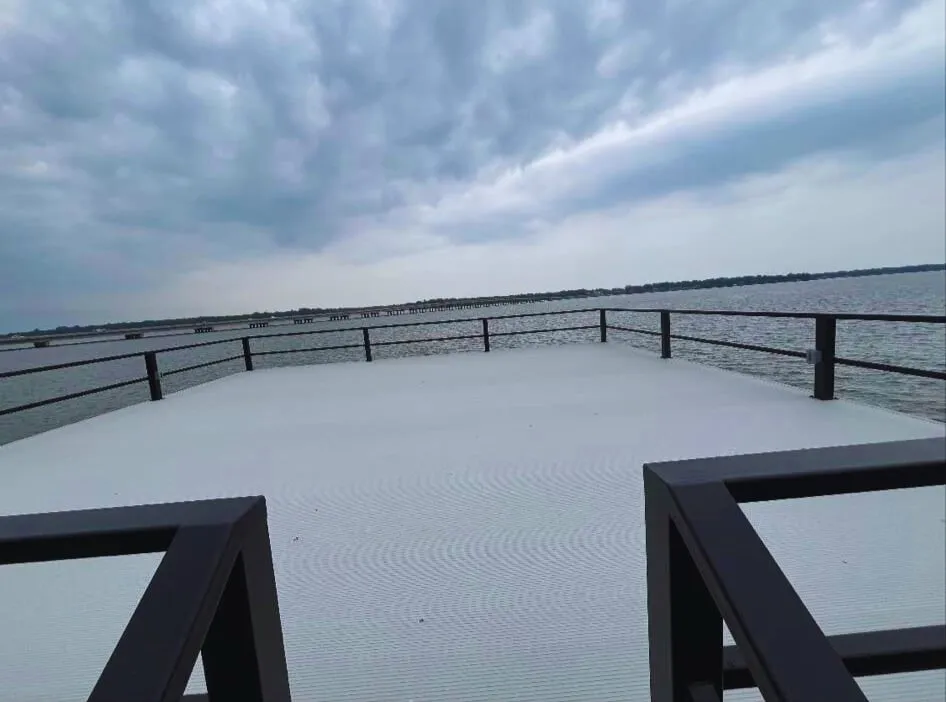 Snow covered patio with a water view