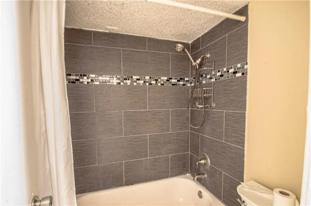 Shower-over-tub combination with large format gray tile surround