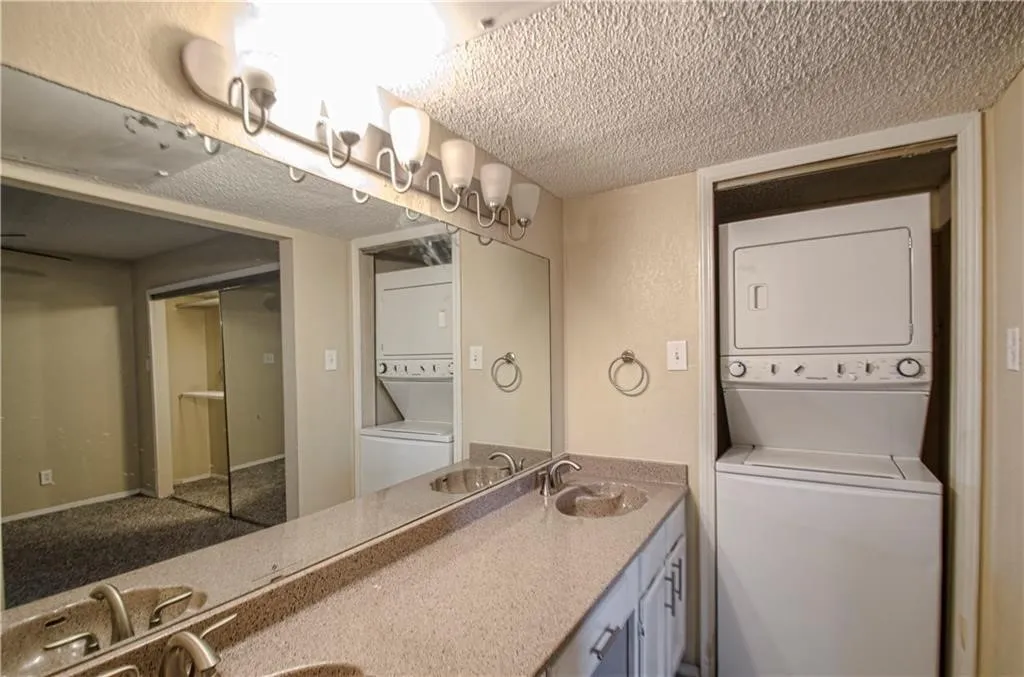 Double vanity with integrated sinks and a speckled countertop