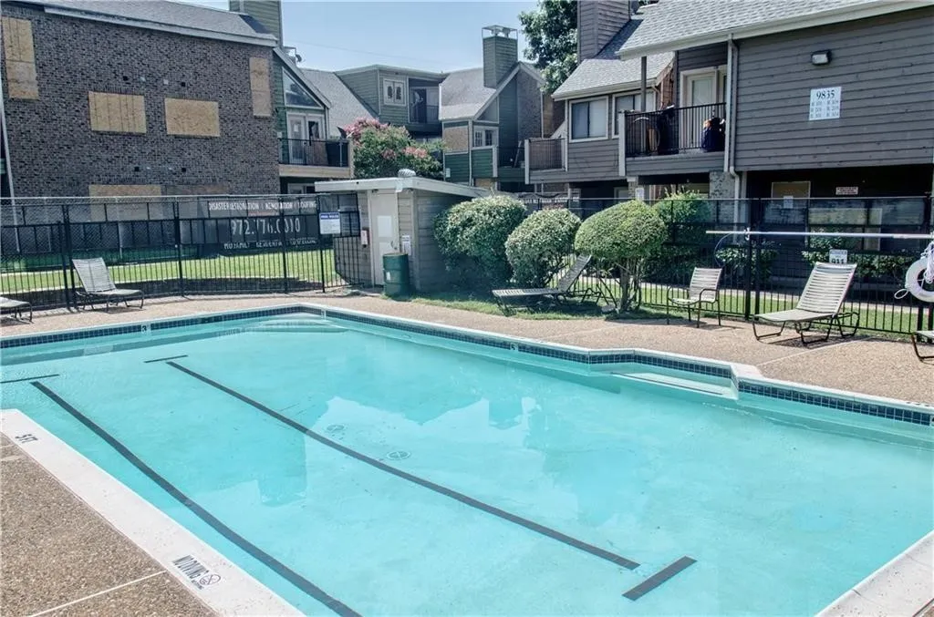 Community swimming pool featuring a tiled perimeter and depth markers