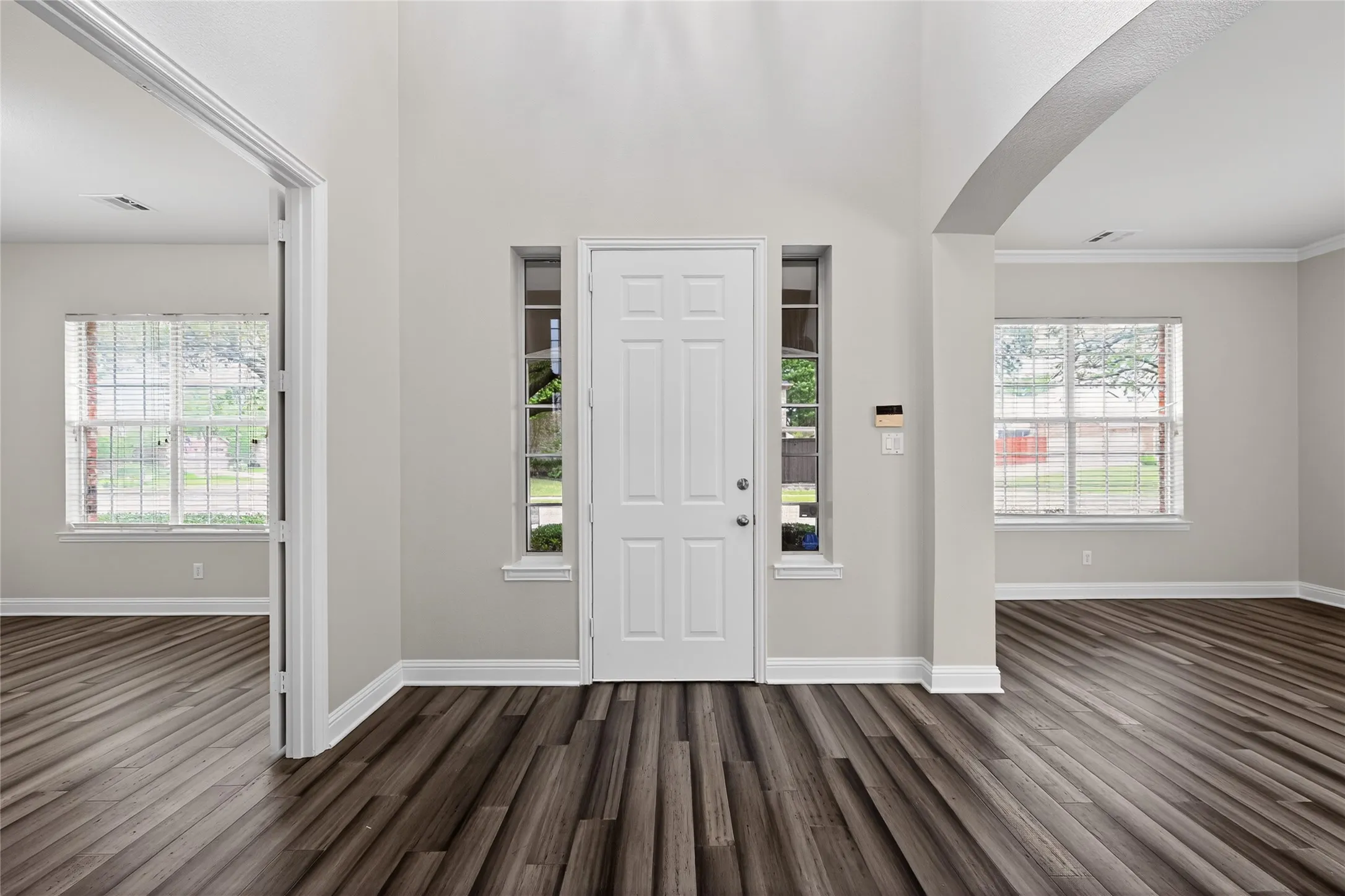 Entryway featuring on the left an office with double doors and closet.This room could be used as a 5th bedroom. on the right is second living area with formal dining.