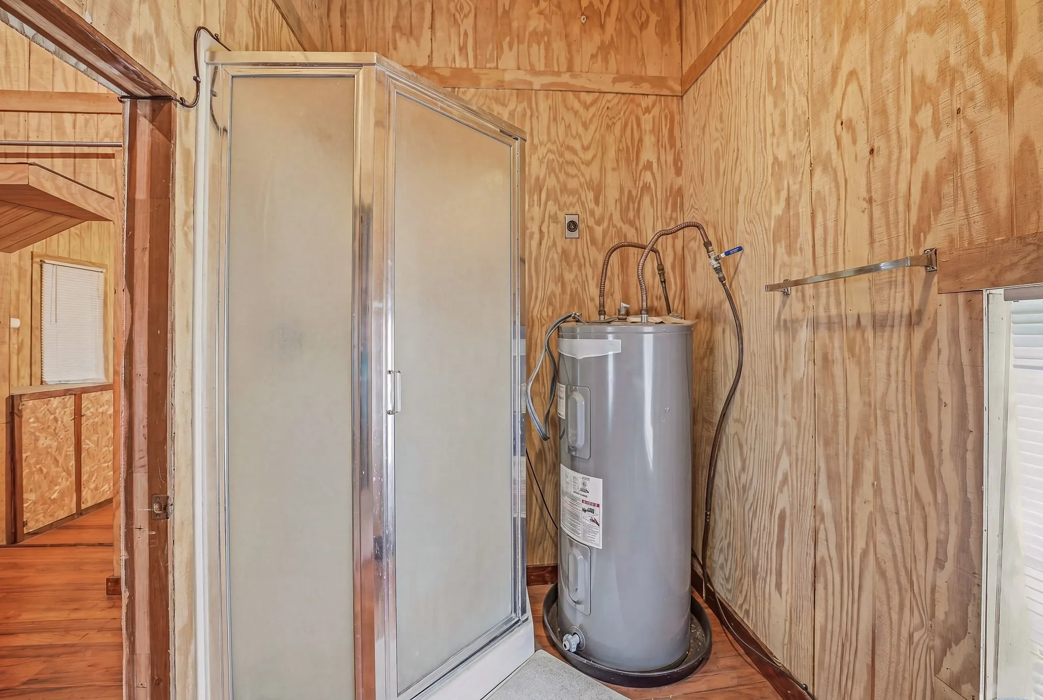 Compact shower enclosure with frosted glass panels and chrome framing