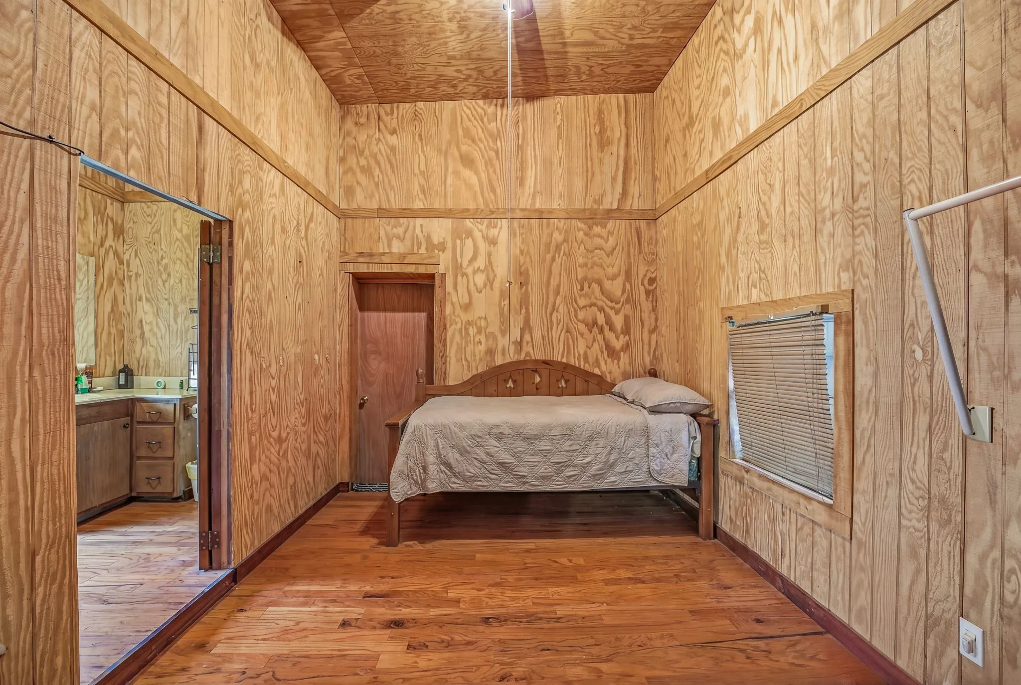 Room featuring wood-finish paneling, wood-finish flooring, and a wood-finish ceiling
