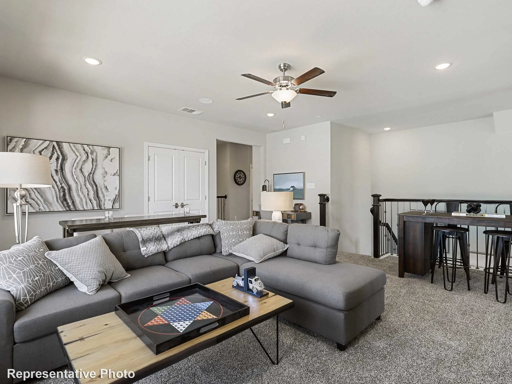 Spacious bonus room featuring plush carpet flooring, recessed lighting, and a ceiling fan