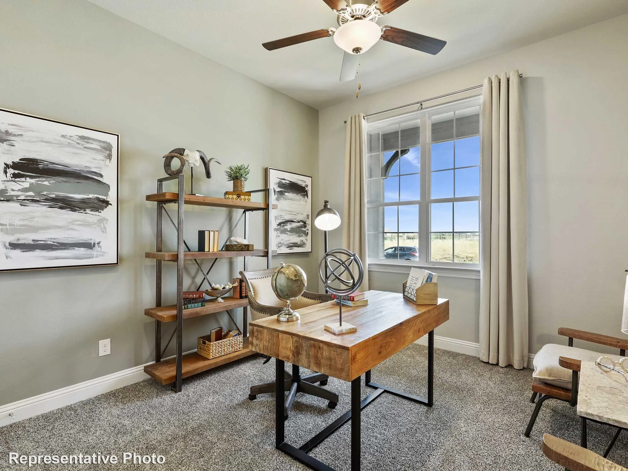 Room featuring a large window, a ceiling fan with integrated lighting, and neutral wall tones